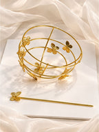 Close-up of butterfly-design bun cage lock detail in gold-finish brass