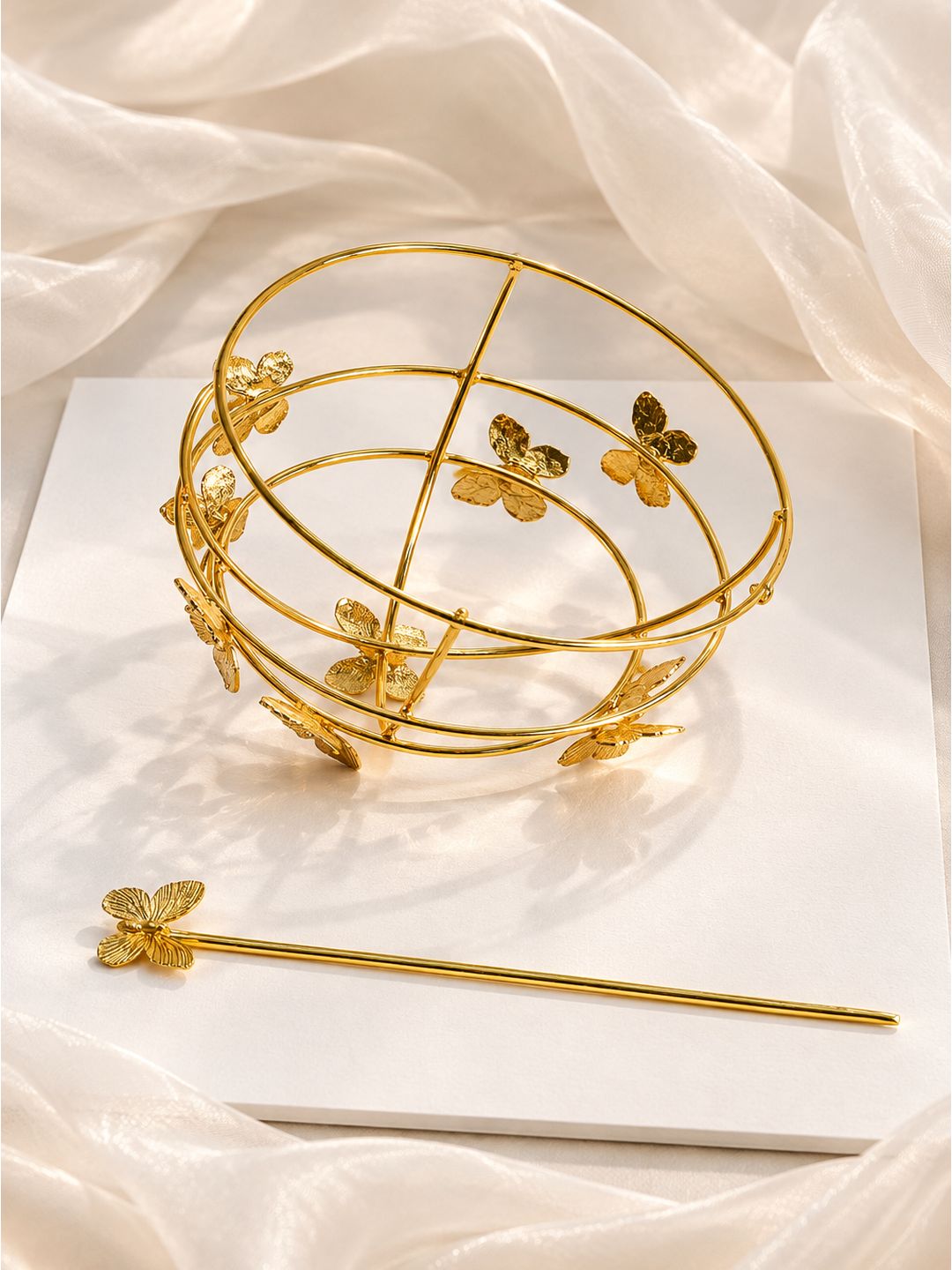Close-up of butterfly-design bun cage lock detail in gold-finish brass
